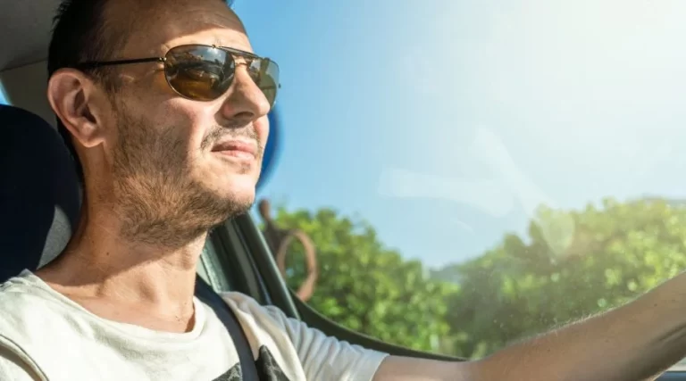 man wearing sunglasses while riding a car